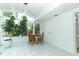 Well-lit sunroom featuring tiled floor, a dining area, and a large potted plant at 3317 Dormer Ct, Winter Park, FL 32792
