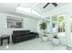 Bright sunroom with white walls, tile floors, and views of the kitchen and the beautiful, private backyard at 3317 Dormer Ct, Winter Park, FL 32792