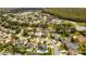 Wide aerial view of houses in a residential neighborhood near a lake and green space at 3532 Amaca Cir, Orlando, FL 32837