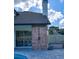 Stylish outdoor shower adjacent to a sliding glass door, accompanied by patio furniture and a lush green yard at 3532 Amaca Cir, Orlando, FL 32837
