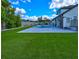 Expansive backyard featuring a beautiful pool, manicured lawn, pergola, patio, and privacy fence at 3532 Amaca Cir, Orlando, FL 32837