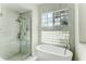Luxurious bathroom with a modern tub, glass shower, and beautiful marble tile for a spa-like experience at 3532 Amaca Cir, Orlando, FL 32837