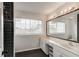 Bright bathroom with a double vanity, large mirror, and sleek fixtures offers a functional and stylish space at 3532 Amaca Cir, Orlando, FL 32837
