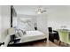 Bedroom with hardwood floors, a window seat, a ceiling fan, a desk and a comfortable bed at 3532 Amaca Cir, Orlando, FL 32837
