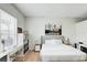Comfortable bedroom with a cozy bed, natural light from the window, a functional desk, and ample storage space at 3532 Amaca Cir, Orlando, FL 32837