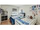 Bright bedroom features two twin beds, hardwood floors, a window seat and decorated walls at 3532 Amaca Cir, Orlando, FL 32837