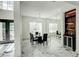 Elegant dining room with modern chandelier, mirrored wall, and a built-in bar area at 3532 Amaca Cir, Orlando, FL 32837
