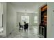 Bright dining room with elegant marble floors, modern chandelier, and mirrored accent wall at 3532 Amaca Cir, Orlando, FL 32837