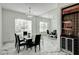 Elegant dining room with marble floors, mirrored wall, chandelier, and a built-in bar area at 3532 Amaca Cir, Orlando, FL 32837