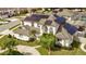 Aerial view of a beautiful two-story home, featuring solar panels on the roof and lush landscaping around the property at 3532 Amaca Cir, Orlando, FL 32837