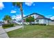 Two-story home with lush front yard landscaping, a curved driveway, and solar panels on the roof at 3532 Amaca Cir, Orlando, FL 32837