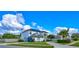 Bright, two-story home with well-manicured lawn, mature landscaping, and solar panels on the roof at 3532 Amaca Cir, Orlando, FL 32837