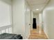 Upstairs hallway with hardwood floors, neutral paint, and several doors leading to other rooms at 3532 Amaca Cir, Orlando, FL 32837