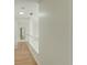 Hallway on the second story has hardwood floors, white paint, and natural light at 3532 Amaca Cir, Orlando, FL 32837