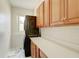 Efficient laundry room boasts a stacked washer/dryer unit, ample counter space, and storage cabinets for convenience at 3532 Amaca Cir, Orlando, FL 32837