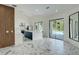 Open-concept living room with marble floors, kitchen, and sliding glass doors to the pool at 3532 Amaca Cir, Orlando, FL 32837