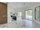 Open-concept living room with marble floors, kitchen, and sliding glass doors to the pool at 3532 Amaca Cir, Orlando, FL 32837