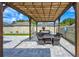 Covered patio with brick flooring, wood pergola and outdoor furniture, perfect for entertaining at 3532 Amaca Cir, Orlando, FL 32837