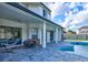 Covered patio featuring a ceiling fan, patio furniture, and a hammock, perfect for relaxation near the pool at 3532 Amaca Cir, Orlando, FL 32837