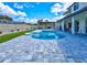 Backyard with an inviting pool, an outdoor dining area beneath a pergola, and manicured landscaping at 3532 Amaca Cir, Orlando, FL 32837