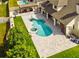 Aerial view of a backyard oasis featuring a custom pool, spa, and outdoor living area with pergola at 3532 Amaca Cir, Orlando, FL 32837