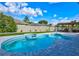 Beautiful backyard swimming pool with a spa, surrounded by well-maintained landscaping and a charming pergola at 3532 Amaca Cir, Orlando, FL 32837