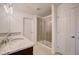 Bright bathroom featuring a glass shower, granite countertop, double sinks and tile flooring at 3565 Dahlia Dr, Lake Hamilton, FL 33851