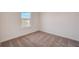 Bedroom featuring carpet, window, and white walls at 3565 Dahlia Dr, Lake Hamilton, FL 33851