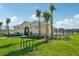 Exterior of the clubhouse features lush landscaping and palm trees at 3565 Dahlia Dr, Lake Hamilton, FL 33851