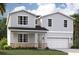 Charming two-story home with gray siding, stone accents, and a well-manicured lawn at 3565 Dahlia Dr, Lake Hamilton, FL 33851