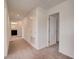 Carpeted upstairs hallway with a closet and an open doorway to the bathroom at 3565 Dahlia Dr, Lake Hamilton, FL 33851