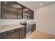 Kitchen featuring granite countertops, stainless steel appliances, and dark cabinets at 3565 Dahlia Dr, Lake Hamilton, FL 33851