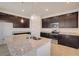 Open kitchen features stainless appliances, granite counters and dark wood cabinets at 3565 Dahlia Dr, Lake Hamilton, FL 33851