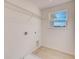 Bright laundry room with tile flooring and a window at 3565 Dahlia Dr, Lake Hamilton, FL 33851