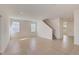 Bright living room featuring tile floors, staircase, and neutral paint palette at 3565 Dahlia Dr, Lake Hamilton, FL 33851