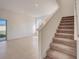 Spacious living room with tile flooring, stairs to second floor, and a sliding glass door at 3565 Dahlia Dr, Lake Hamilton, FL 33851