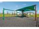 Community playground with swing sets and shaded play area; offering a great space for to play outdoors at 3565 Dahlia Dr, Lake Hamilton, FL 33851