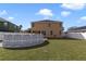 Large backyard with an above-ground pool, green lawn, and white privacy fence at 3680 Ricky Ln, St Cloud, FL 34772