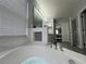 This bathroom features a soaking tub with marble accents and wood-style flooring at 3680 Ricky Ln, St Cloud, FL 34772