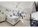 Bright bedroom with a ceiling fan, large windows, artwork, and comfortable furniture at 3680 Ricky Ln, St Cloud, FL 34772