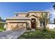 Inviting home with a two-car garage, warm colors, and stone veneer accents at 3680 Ricky Ln, St Cloud, FL 34772