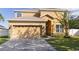 Inviting home with a two-car garage, warm colors, and stone veneer accents at 3680 Ricky Ln, St Cloud, FL 34772