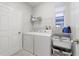 Laundry room with washer, dryer, storage shelves, and natural light at 3680 Ricky Ln, St Cloud, FL 34772