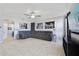 Living room with large sectional couch, television, and ceiling fan at 3680 Ricky Ln, St Cloud, FL 34772