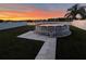 Above-ground pool set against a colorful sunset sky in a fenced backyard at 3680 Ricky Ln, St Cloud, FL 34772