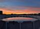 Above-ground pool under a sky with vibrant sunset colors reflecting on the water at 3680 Ricky Ln, St Cloud, FL 34772