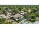 Aerial view of a home with a screened enclosure, a pool, and a fenced yard at 4021 Hargill Dr, Orlando, FL 32806