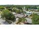 Aerial view of a home with mature landscaping, a screened enclosure, and a pool at 4021 Hargill Dr, Orlando, FL 32806