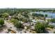 Aerial view of a home with mature landscaping, a pool, and a nearby lake at 4021 Hargill Dr, Orlando, FL 32806