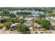 Aerial view of a home with a pool, mature trees, and a nearby lake at 4021 Hargill Dr, Orlando, FL 32806